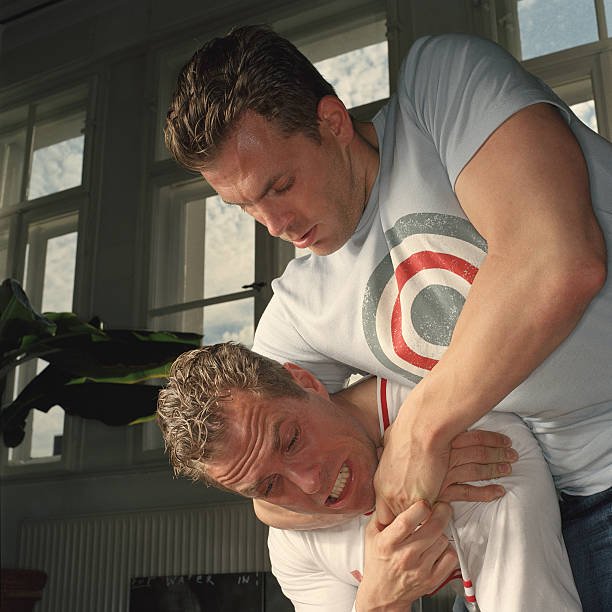 identical twin brothers wrestling, one with other in headlock - head lock stock pictures, royalty-free photos & images