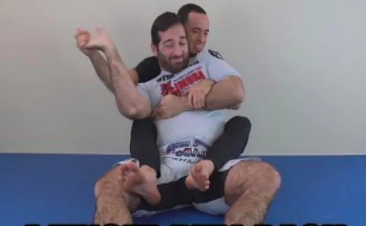 Close-up of a back control choking grip used in the no-gi bow and arrow choke
