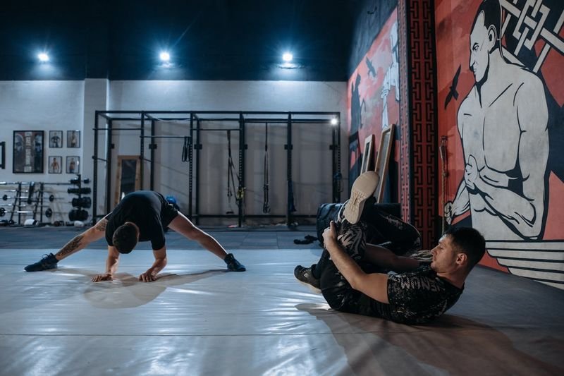 Grapplers doing mobility and breathing drills before no-gi training, part of a staged return from a rib injury