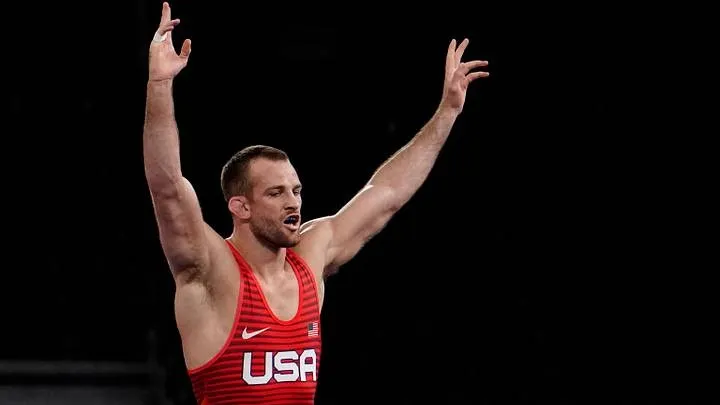 Olympic gold medalist David Taylor, known for his ankle pick takedowns, celebrates a win