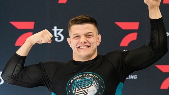 Jacob Couch celebrates in no-gi rashguard in the medium heavyweight bracket