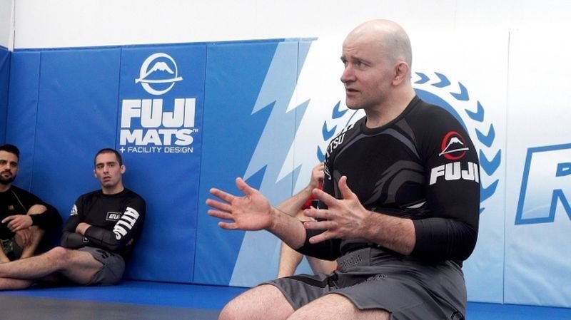 John Danaher coaching no-gi grappling on the mats