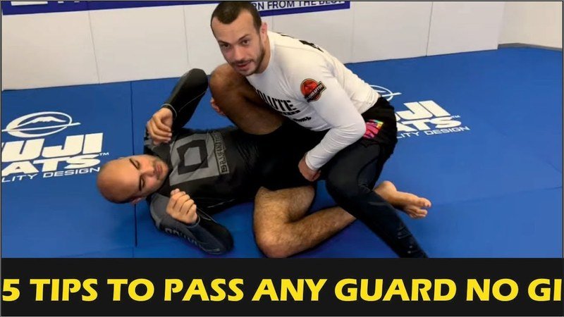 No-gi grappler controlling the legs in top guard-passing position, a setup used in the long step pass