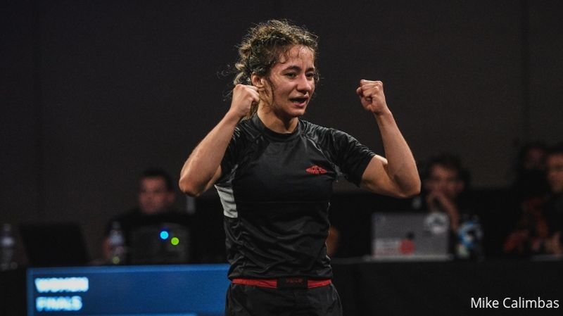 Mayssa Bastos celebrating a no-gi Pan championship win in a black rashguard