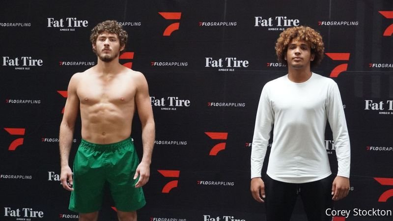No-gi grapplers of different weight classes stand together after making weight